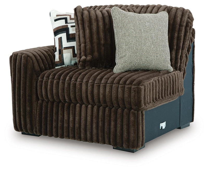 Ashley Furniture Midnight-Madness sectional sofa shown from an angled view, featuring dark fabric and plush cushions.