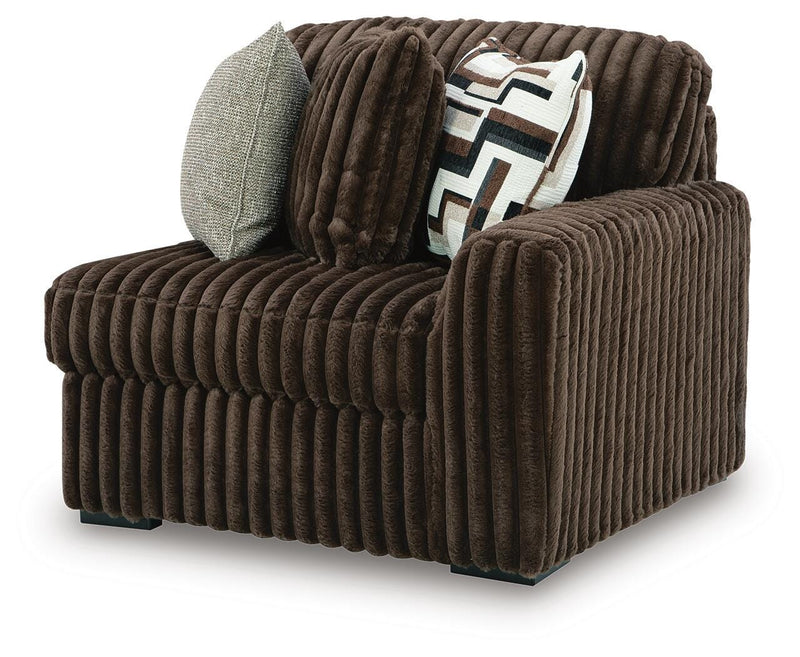 Ashley Furniture Midnight-Madness Sectional Sofa shown from an angled side view with plush cushions and modern design.