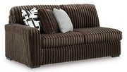 Ashley Furniture Midnight-Madness sectional sofa shown from an angled view, featuring dark upholstery and plush cushions.