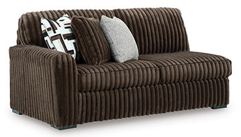 Ashley Furniture Midnight-Madness sectional sofa shown from an angled view, featuring dark upholstery and plush cushions.