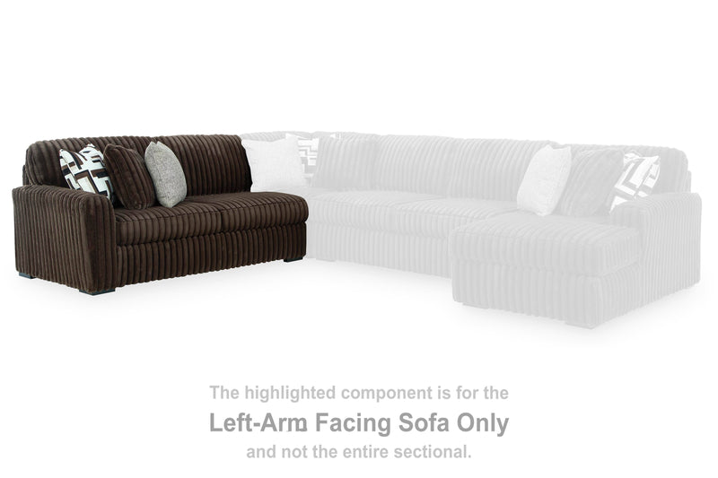 Ashley Furniture Midnight-Madness sectional with chaise, showing dark upholstered fabric and contemporary design in a living room setting.