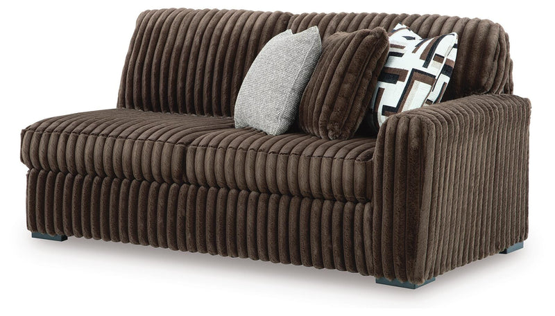 Ashley Furniture Midnight-Madness sectional with chaise, showing dark fabric upholstery and modern design from an angled view.