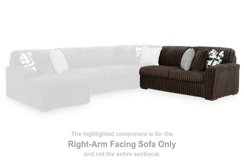 Ashley Furniture Midnight-Madness sectional sofa with plush cushions and dark upholstery, shown in a modern living room setting.