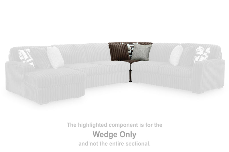 Ashley Furniture Midnight-Madness sectional sofa with dark fabric, plush cushions, and modern design in a spacious living room setting.