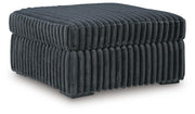 Ashley Furniture Midnight-Madness oversized accent ottoman with plush fabric and modern design, viewed from an angled perspective.
