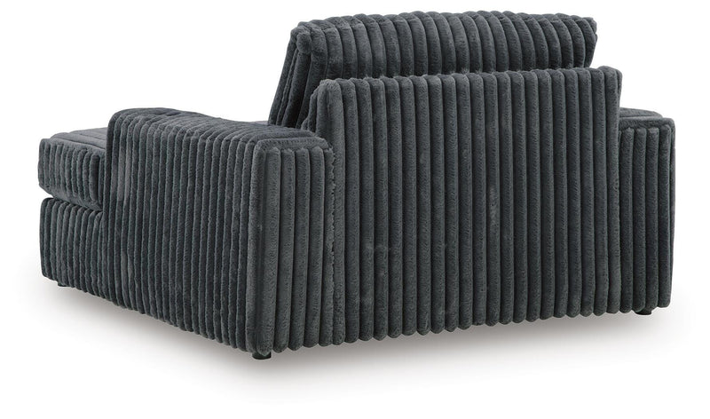 Ashley Furniture Midnight-Madness oversized chaise chair with plush upholstery and a modern design, shown from the back.