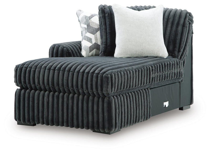 Ashley Furniture Midnight-Madness sectional with chaise, showing a modern L-shaped sofa in dark fabric with plush cushions.