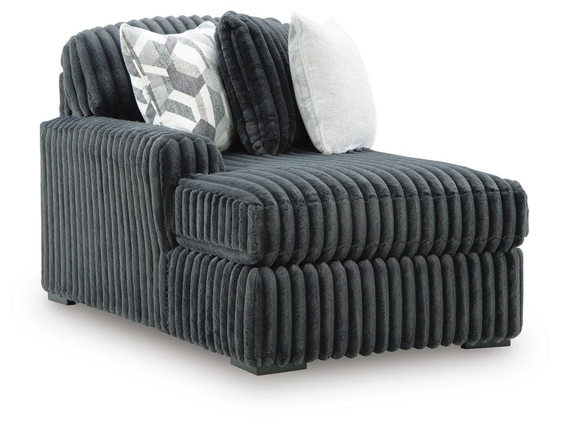 Ashley Furniture Midnight-Madness sectional with chaise, featuring dark upholstery and modern design, shown in an angled view.