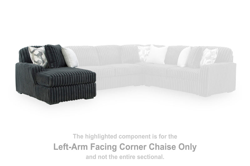 Ashley Furniture Midnight-Madness sectional with chaise, featuring plush fabric, modern design, and comfortable seating arrangement.