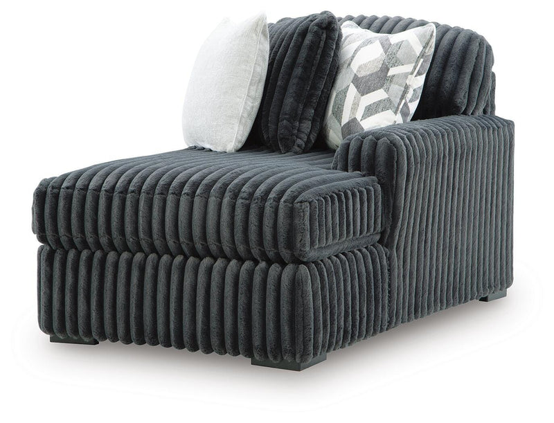 Ashley Furniture Midnight-Madness sectional with chaise, showing dark fabric upholstery and contemporary design from an angled view.