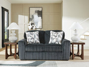 Midnight-Madness Ashley Furniture loveseat with plush dark upholstery and cozy cushioned seating.