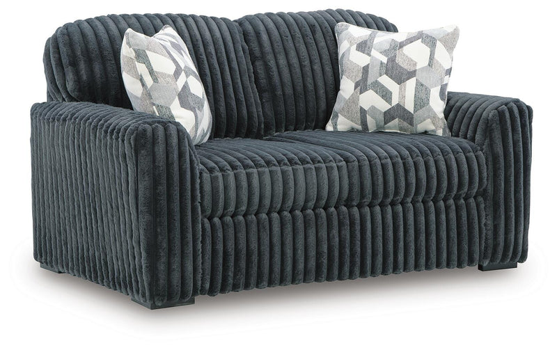 Ashley Furniture Midnight-Madness loveseat shown from an angled view, featuring plush fabric and stylish design for cozy living spaces.