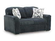 Ashley Furniture Midnight-Madness Loveseat shown from an angle, featuring plush fabric and modern design for cozy living room comfort.