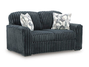 Ashley Furniture Midnight-Madness Loveseat shown from an angle, featuring plush fabric and modern design for cozy living room comfort.
