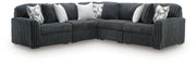 Ashley Furniture Midnight-Madness sectional with dark fabric upholstery and plush cushions, shown in a modern living room setting.