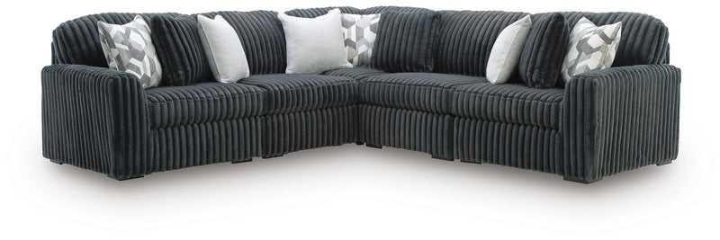 Ashley Furniture Midnight-Madness sectional with dark fabric upholstery and plush cushions, shown in a modern living room setting.