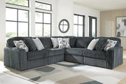 Ashley Furniture Midnight-Madness sectional in dark upholstery with plush cushions and modern design, shown in a living room setting.