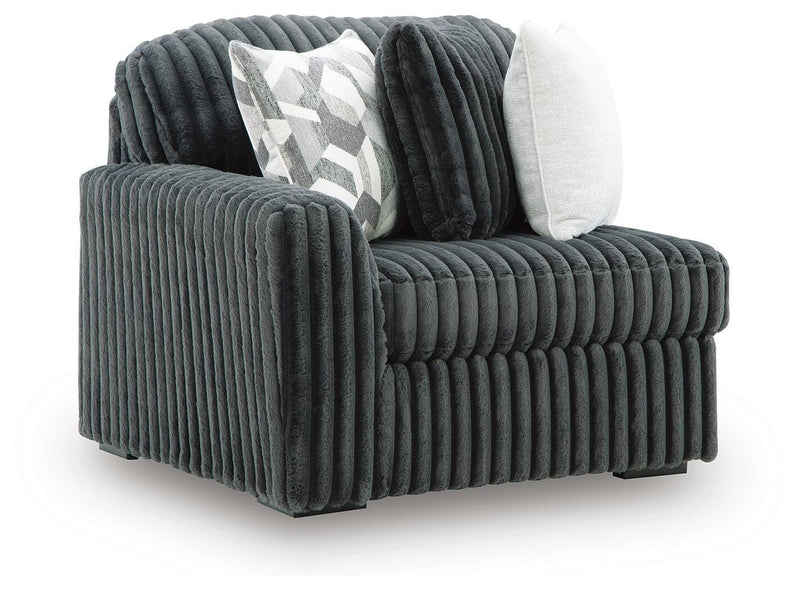 Ashley Furniture Midnight-Madness sectional sofa with plush cushions, modern design, and neutral fabric upholstery, viewed from an angle.