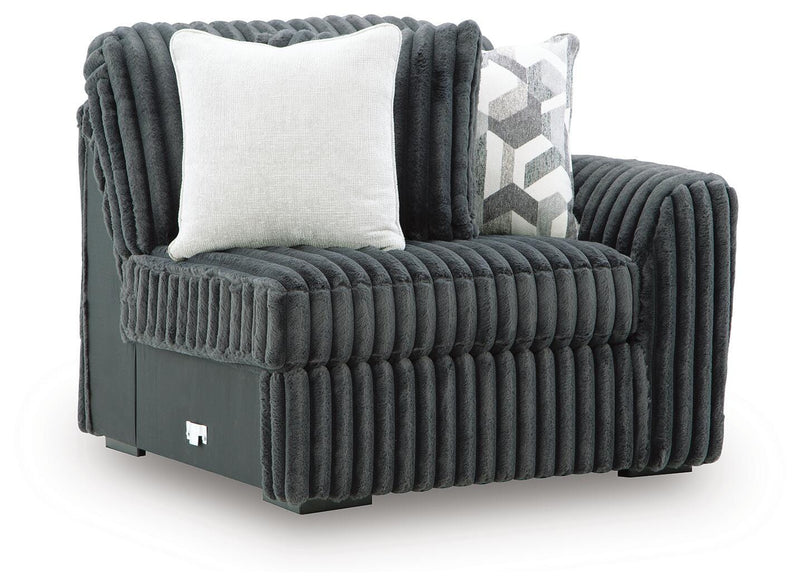Ashley Furniture Midnight-Madness sectional in a modern, dark fabric, shown from an angled view highlighting the spacious seating area.