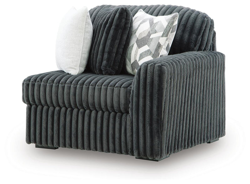 Ashley Furniture Midnight-Madness sectional sofa shown from an angled view, featuring plush cushions and modern design.