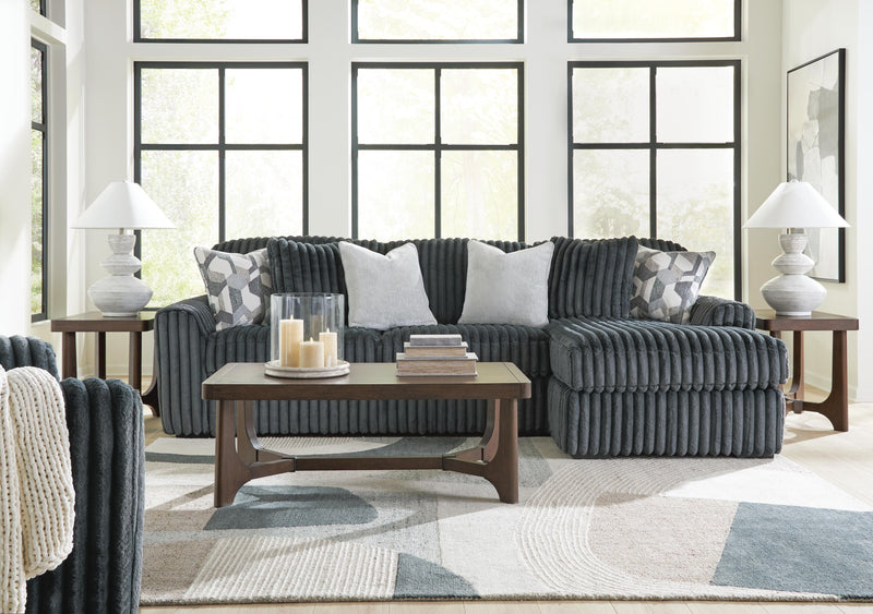 Ashley Furniture Korestone living room table set with two modern occasional tables featuring sleek wooden tops and metal legs.
