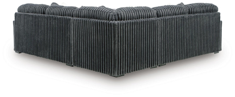 Ashley Furniture Midnight-Madness sectional sofa with plush dark upholstery, shown from the back view with detailed cushions and armrests.