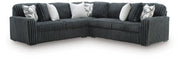 Ashley Furniture Midnight-Madness sectional in dark fabric with plush cushions and modern design, shown in a living room setting.