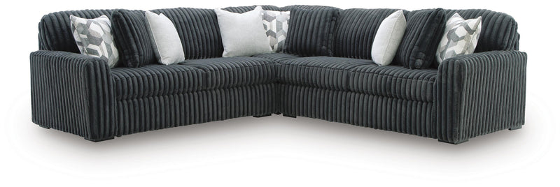 Ashley Furniture Midnight-Madness sectional in dark fabric with plush cushions and modern design, shown in a living room setting.