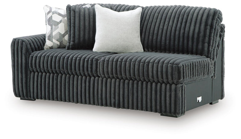 Ashley Furniture Midnight-Madness sectional sofa shown from an angled view, showcasing plush cushions and modern design.