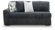 Ashley Furniture Midnight-Madness sectional with plush cushions and dark upholstery, viewed from head-on showing the sofa's detailed design.