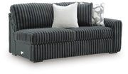 Ashley Furniture Midnight-Madness sectional sofa shown from an angled view, featuring plush cushions and contemporary design.