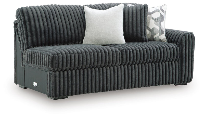 Ashley Furniture Midnight-Madness sectional sofa shown from an angled view, featuring plush cushions and contemporary design.
