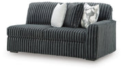 Ashley Furniture Midnight-Madness sectional sofa shown from an angled view, featuring plush cushions and modern design.