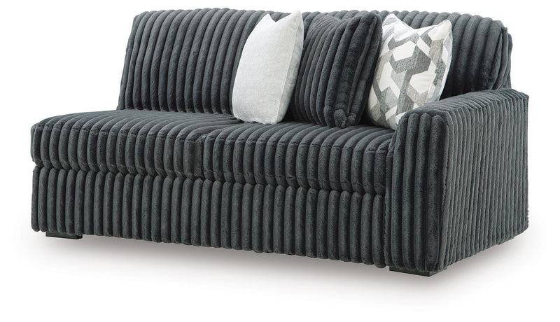 Ashley Furniture Midnight-Madness sectional sofa shown from an angled view, featuring plush cushions and modern design.