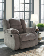 Ashley Furniture Tulen recliner with plush fabric and padded armrests, designed for comfortable seating.