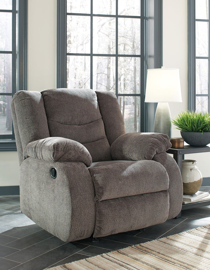 Ashley Furniture Tulen recliner with plush fabric and padded armrests, designed for comfortable seating.