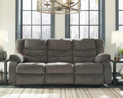 Ashley Furniture Tulen Reclining Sofa with plush cushions and fabric upholstery, shown in a modern living room setting.