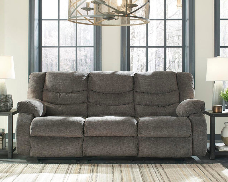 Ashley Furniture Tulen Reclining Sofa with plush cushions and fabric upholstery, shown in a modern living room setting.