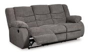 Open view of Ashley Furniture Tulen Living Room Set, including sofa and armchair, in a modern living room setting.