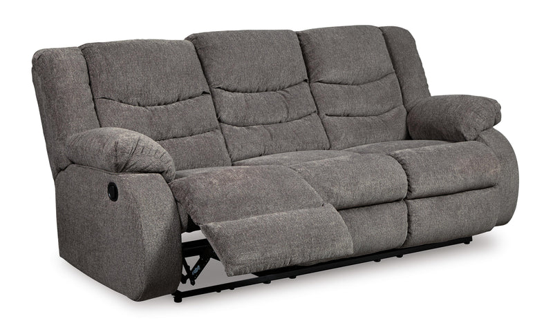 Open view of Ashley Furniture Tulen Living Room Set, including sofa and armchair, in a modern living room setting.