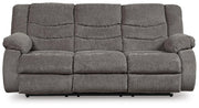 Ashley Furniture Tulen Reclining Sofa in dark brown fabric, showing plush cushions and reclining feature.