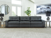 Ashley Furniture Brindley sectional sofa with plush cushions and neutral fabric, shown in a modern living room setting.