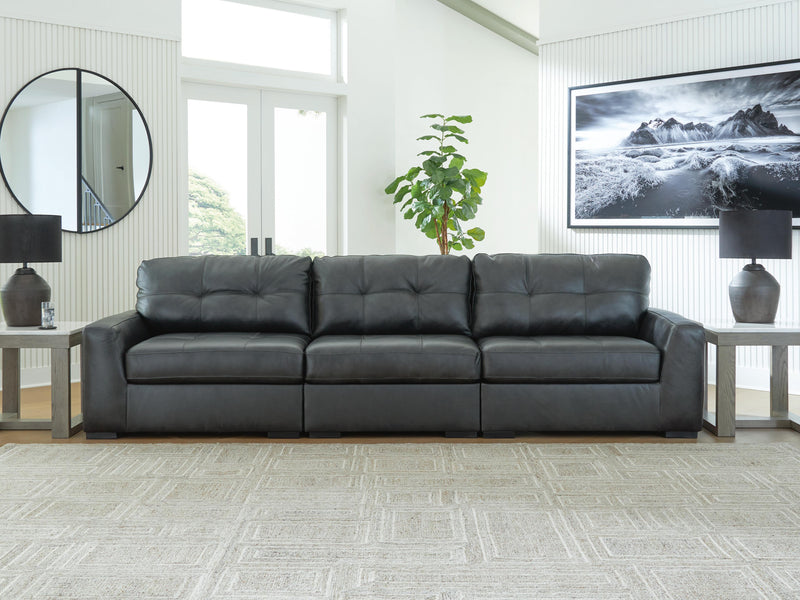 Ashley Furniture Brindley sectional sofa with plush cushions and neutral fabric, shown in a modern living room setting.