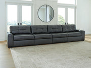 Ashley Furniture Brindley sectional sofa with plush cushions and neutral fabric, shown in a cozy living room setting.