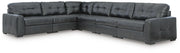 Ashley Furniture Brindley sectional with plush cushions and neutral fabric, shown in a spacious living room setting.