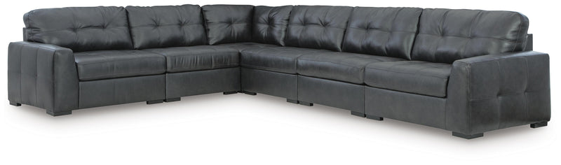 Ashley Furniture Brindley sectional with plush cushions and neutral fabric, shown in a spacious living room setting.