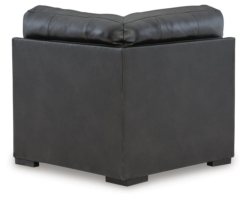Ashley Furniture Brindley sectional sofa with plush cushions and neutral fabric, shown from the back in a modern living room setting.