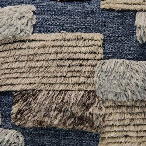 Ashley Furniture Gibbend Pillow, soft fabric with a textured pattern, shown in a close-up view.