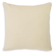 Set of four Ashley Furniture Kydner pillows with neutral fabric covers, displayed in a cozy living room setting.