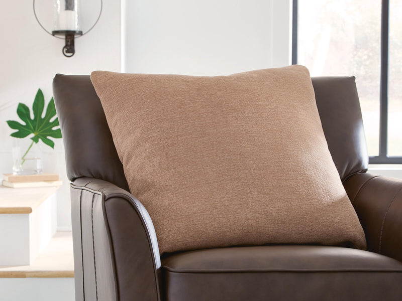 Set of four Ashley Furniture Brockbert pillows with decorative fabric covers, arranged on a neutral-colored sofa.